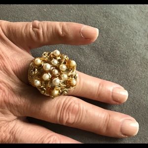 Vintage faux pearl ring watch keeps time.